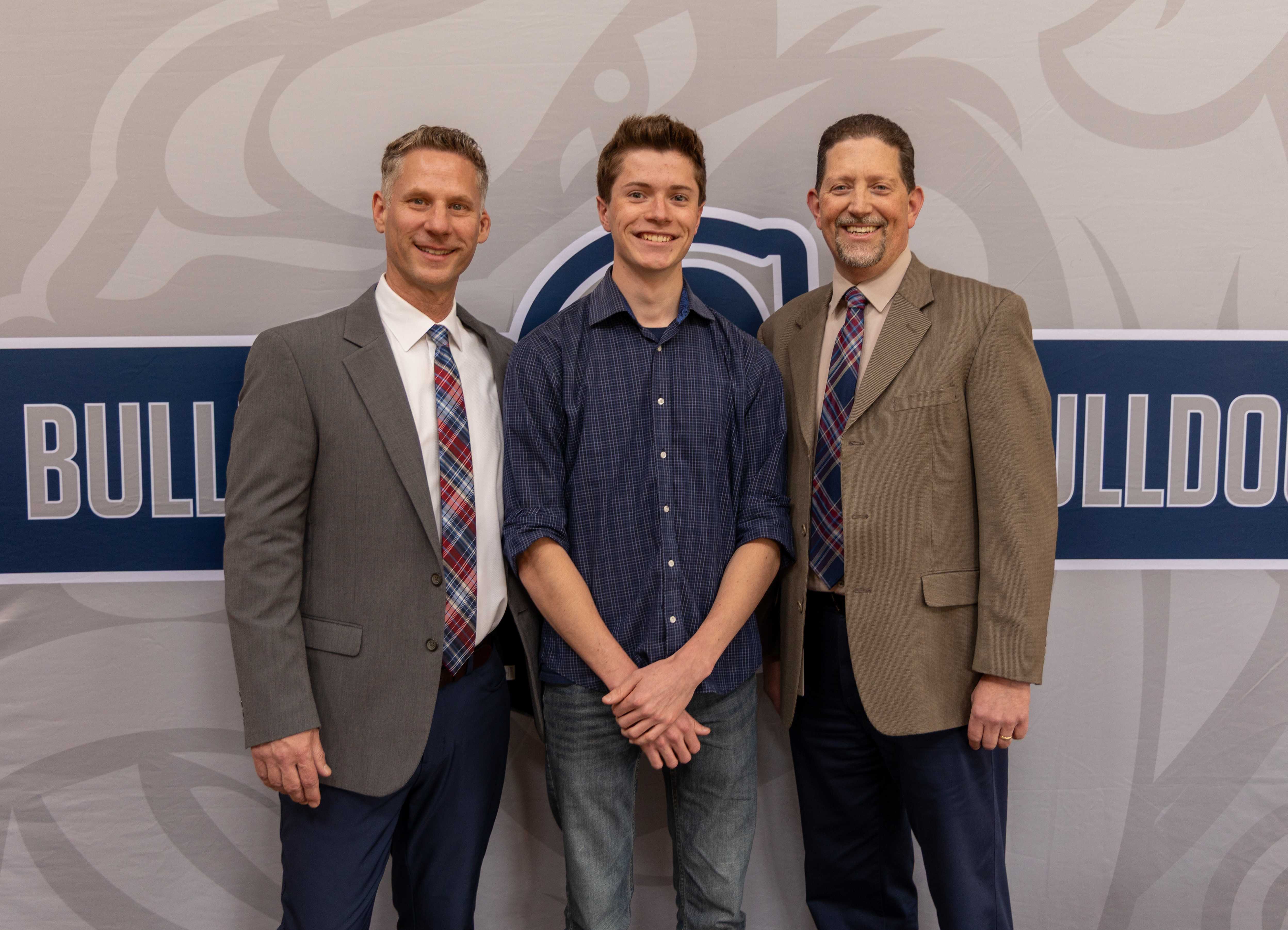 John Hopkins poses with Principal Barr and Superintendent Sickles